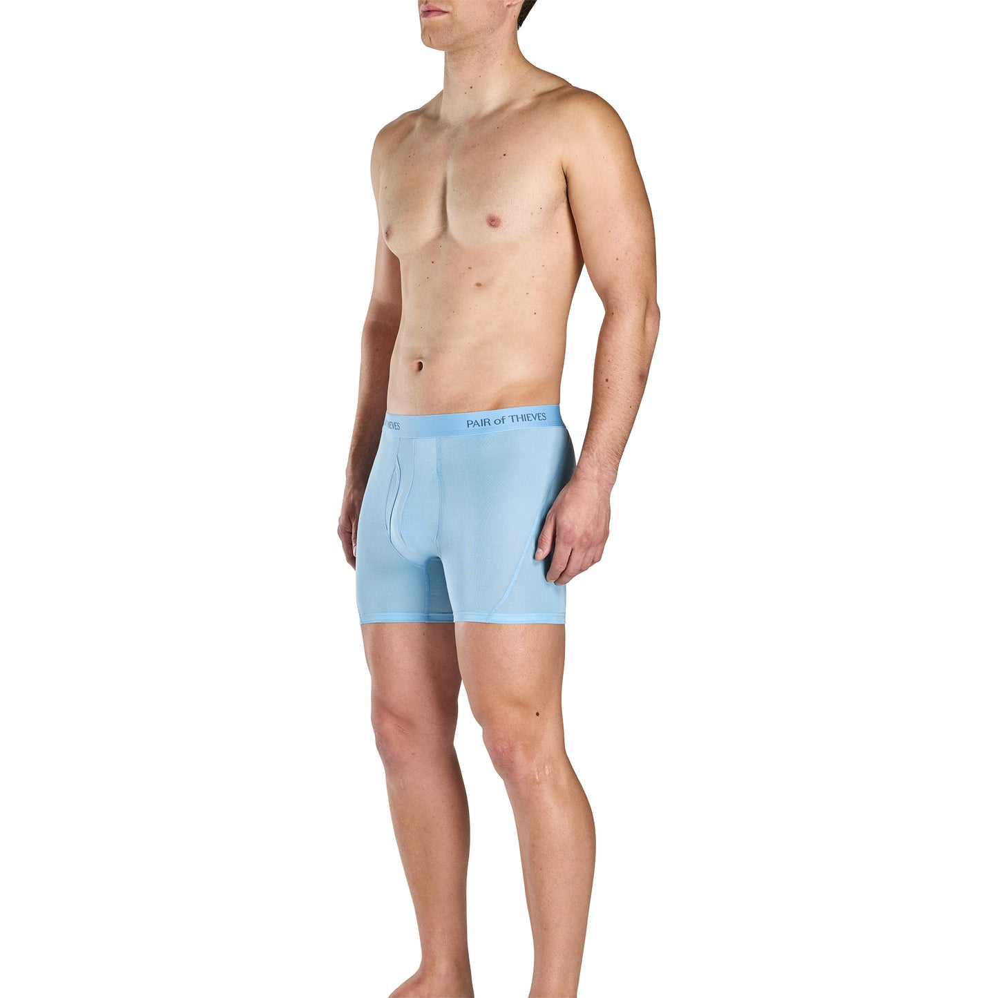 Man wearing light blue boxer briefs with brand logo on a white background
