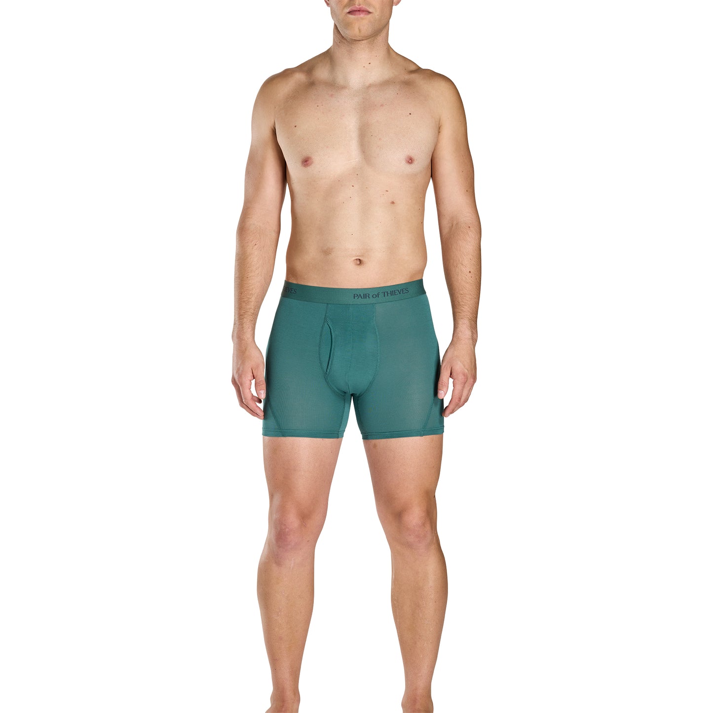 Man wearing green boxer briefs on a white background