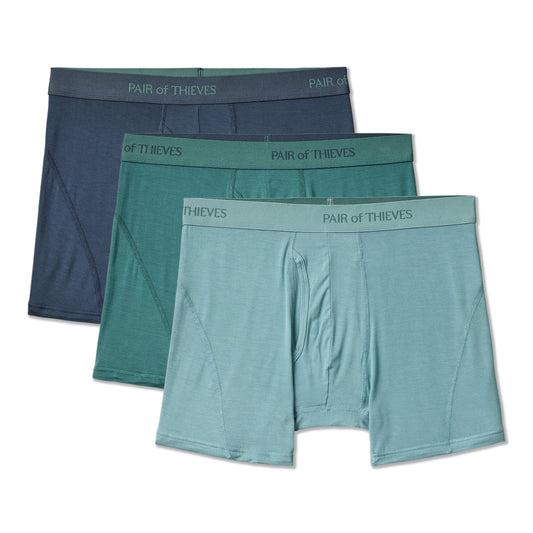 Three pairs of men's underwear in teal and navy with 'Pair of Thieves' branding on a white background.