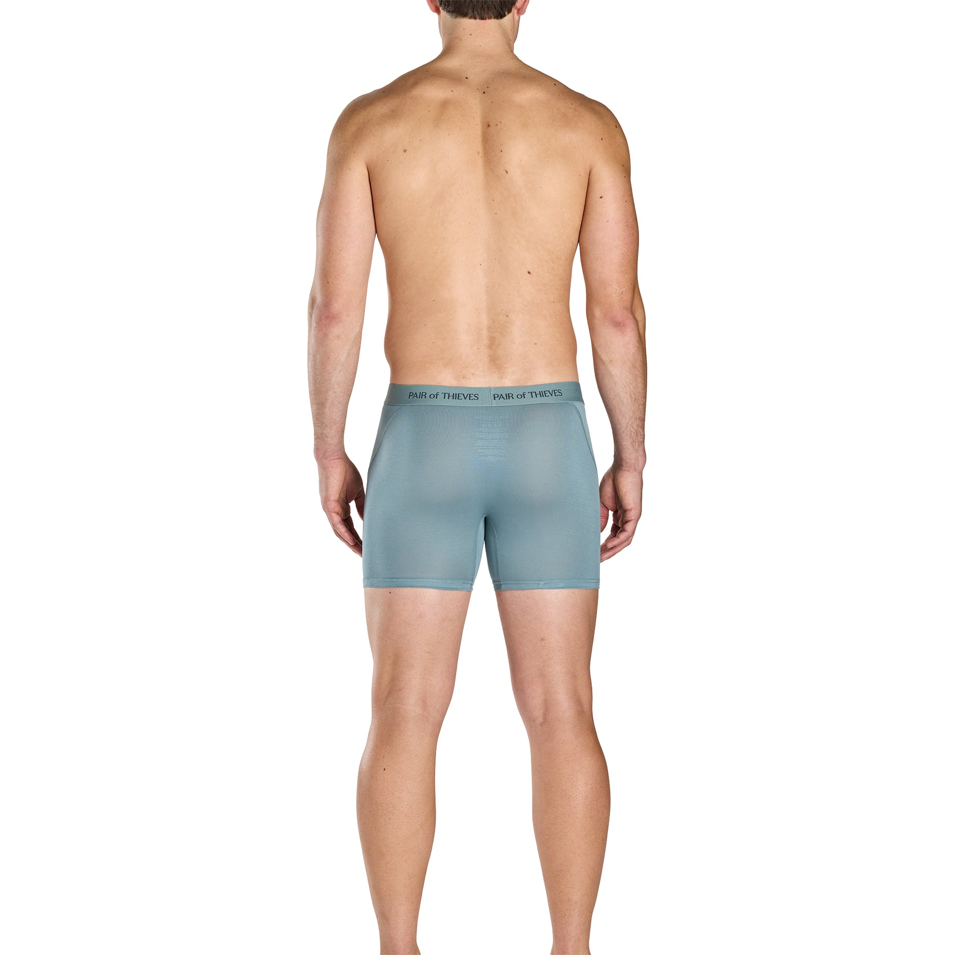 Man wearing light blue boxer briefs on a white background