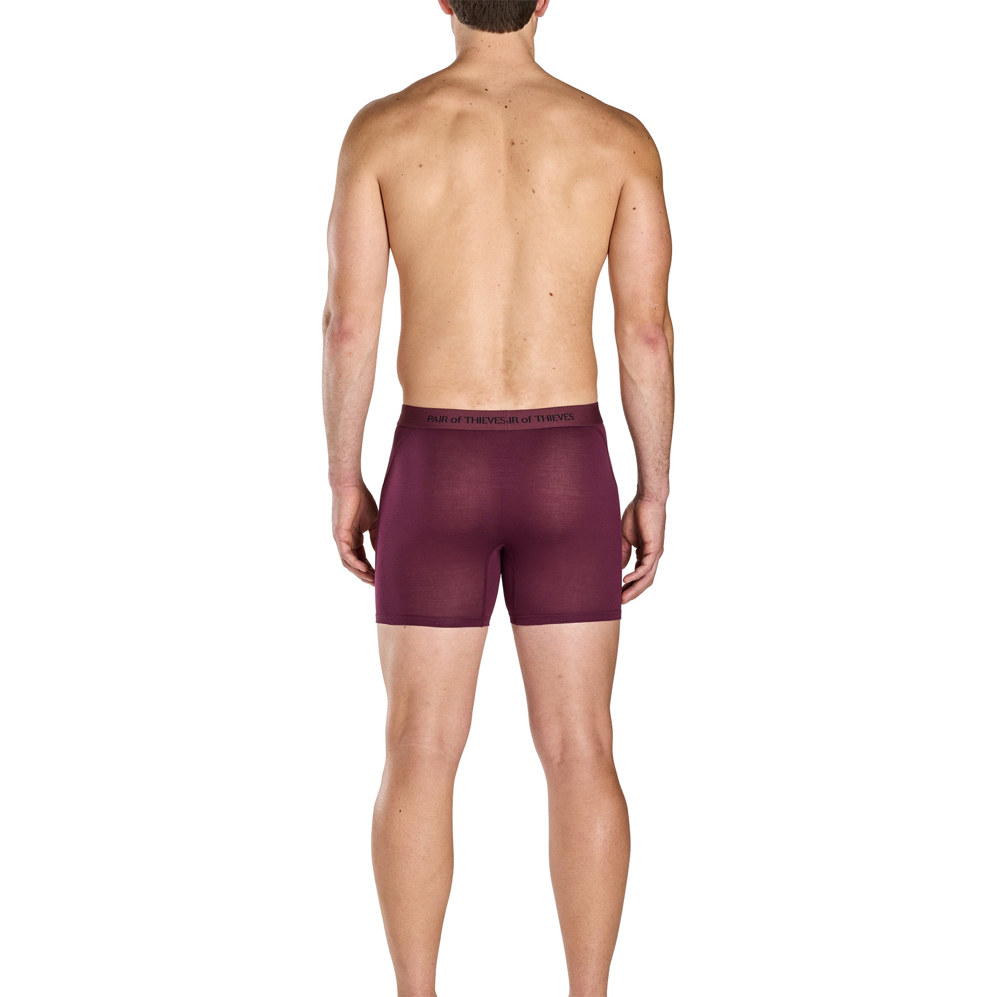 Man wearing a pair of maroon boxer briefs on a white background