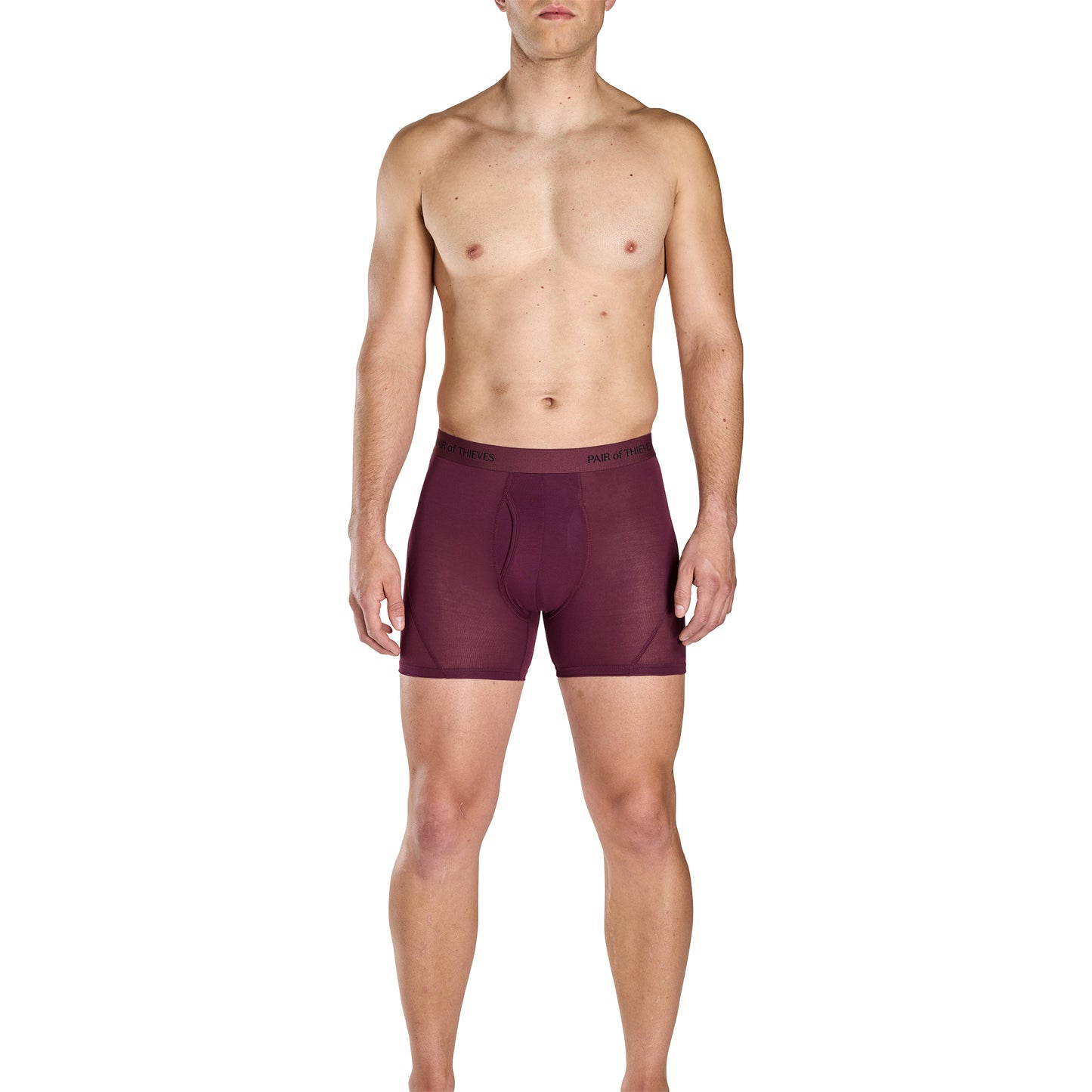 Man wearing maroon boxer briefs on a white background