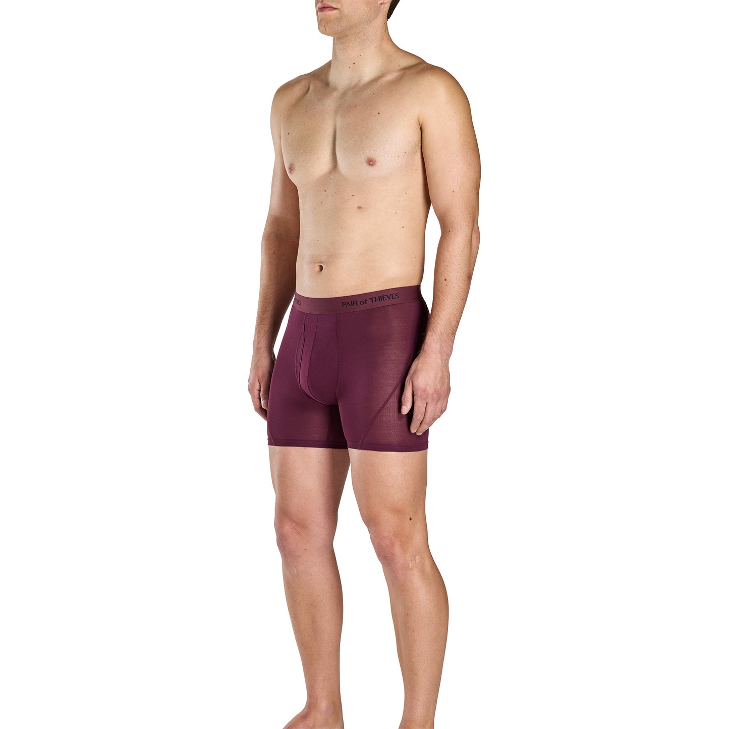 Man wearing maroon boxer briefs on a white background
