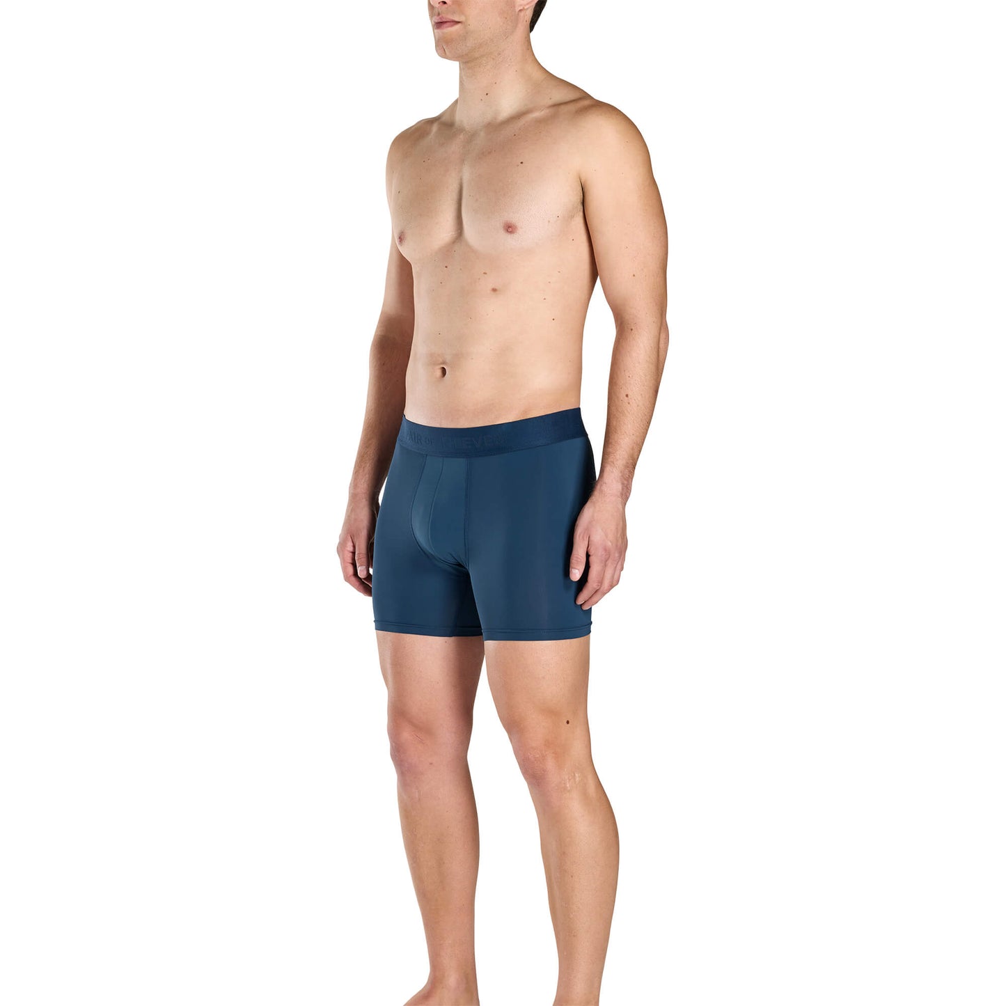 Man wearing blue SuperFit Pouch boxer briefs on a white background showing his front profile.